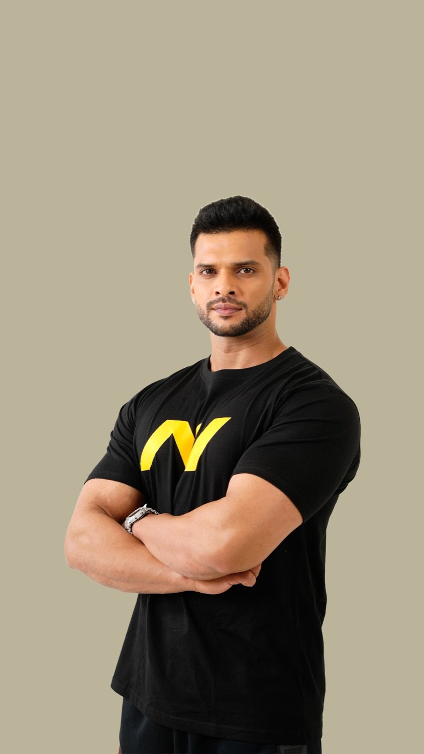 Rahoul Nair, arms folded, in an SNC Planet T-shirt